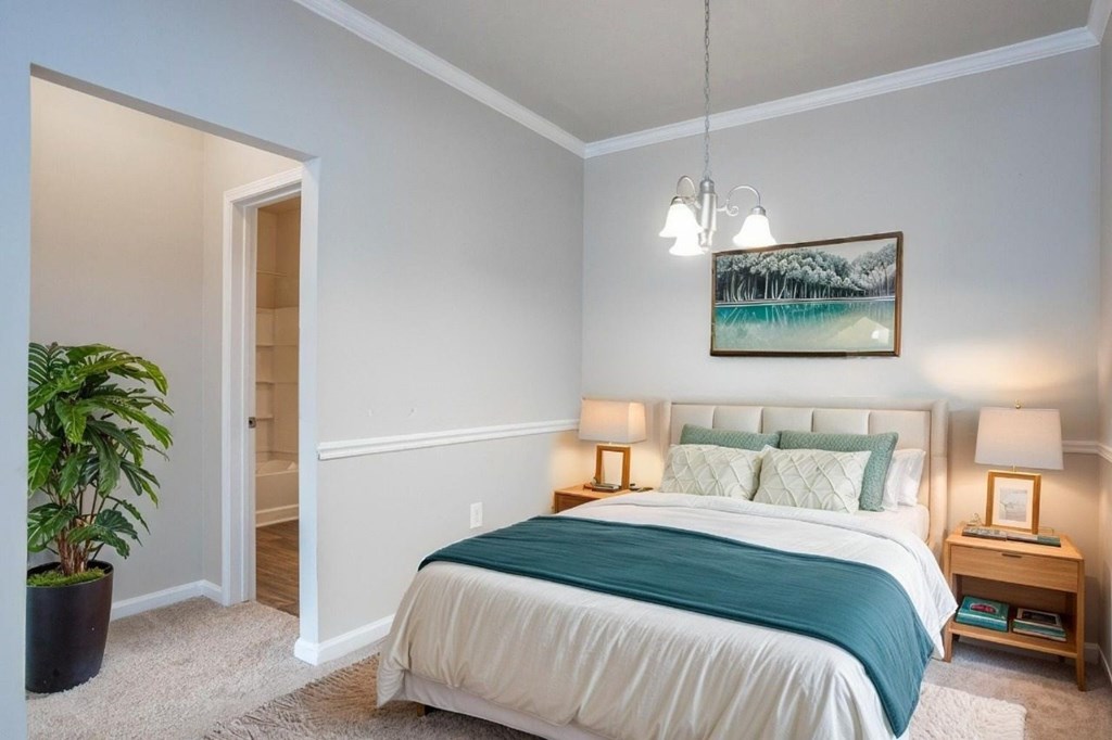 A bedroom with a bed, nightstand, and a painting on the wall.