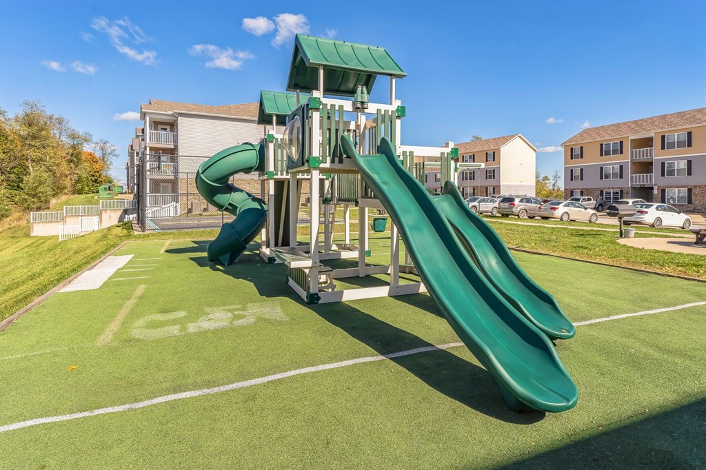a playground with a slide in a park