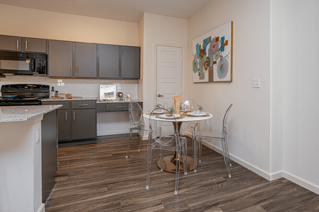 a kitchen with stainless steel appliances and a small table