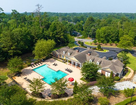 a aerial view of a house with a swimming pool and a mansion