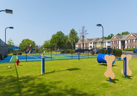 a park with a playground and a volley ball court