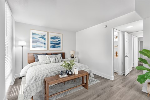 A bedroom with a large bed and a wooden coffee table.