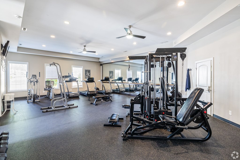 A spacious home gym with a variety of equipment.