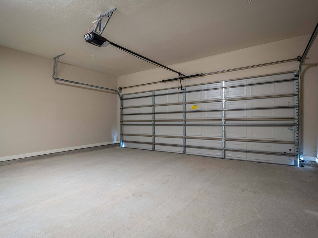 the interior of a garage with a white garage door