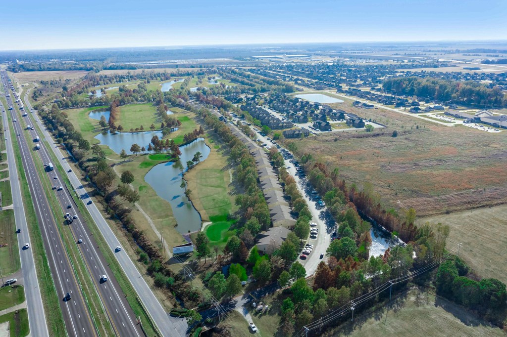 an aerial view of a wetland area next to a highway