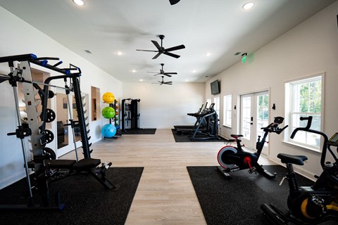 A spacious gym with a variety of exercise equipment.