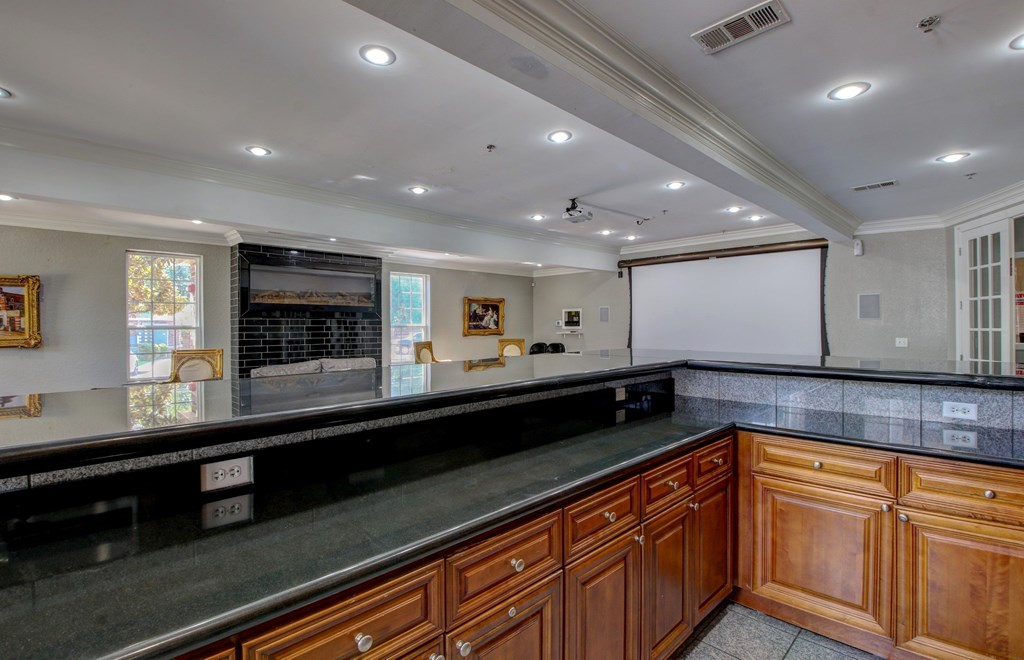 A kitchen with wooden cabinets and a black countertop.