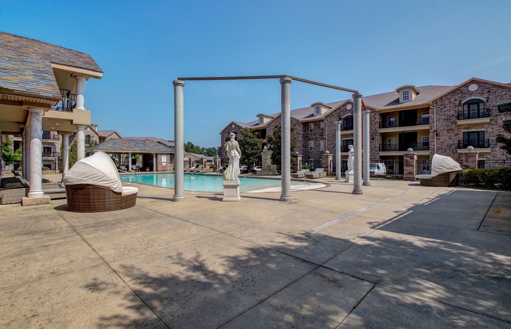 A sunny day at the outdoor pool area of a residential complex.