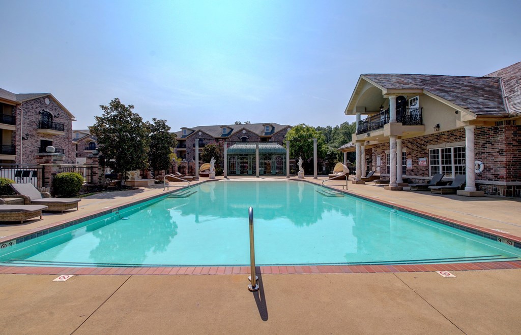 A large swimming pool in front of a resort.