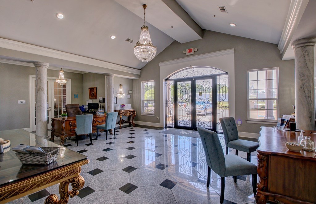 A large, elegant dining room with a checkered floor and a chandelier hanging from the ceiling.