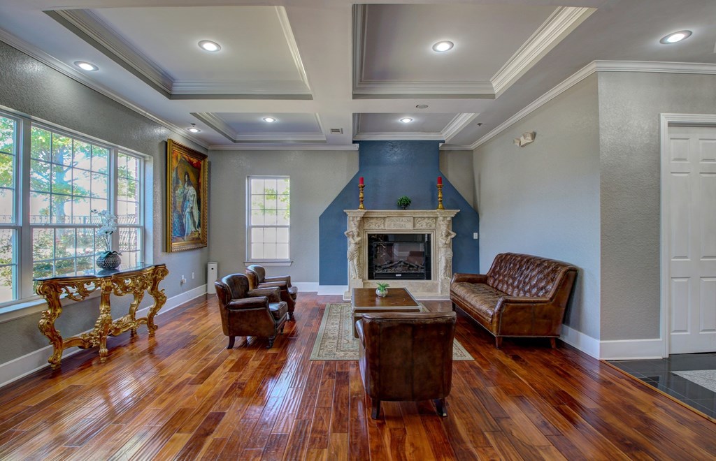 A living room with a fireplace and a painting on the wall.