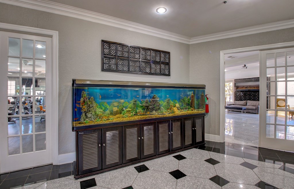 A hallway with a large painting on the wall and a checkered floor.