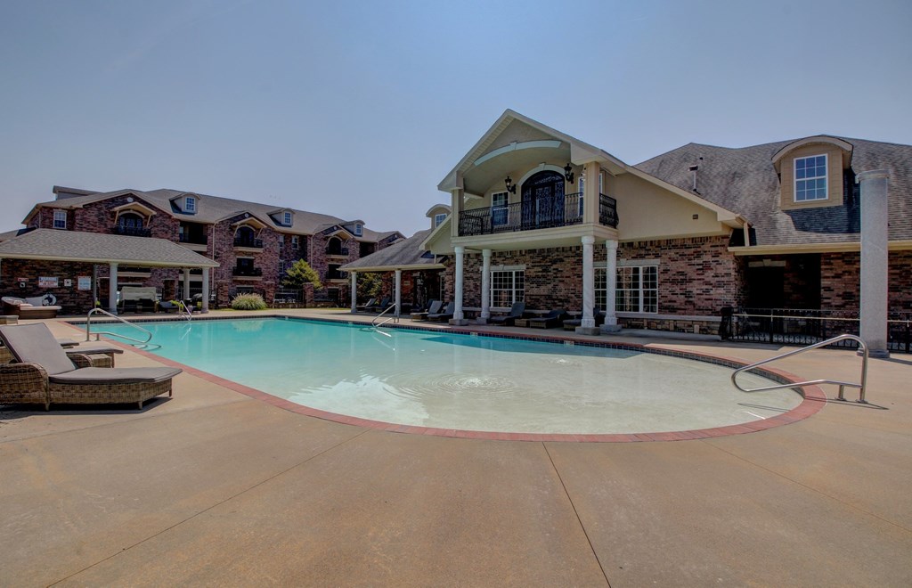 A large house with a pool in front.