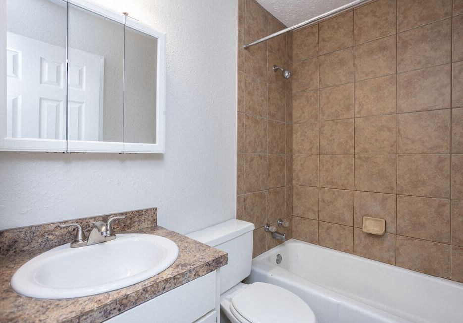 a bathroom with a sink toilet and a bath tub