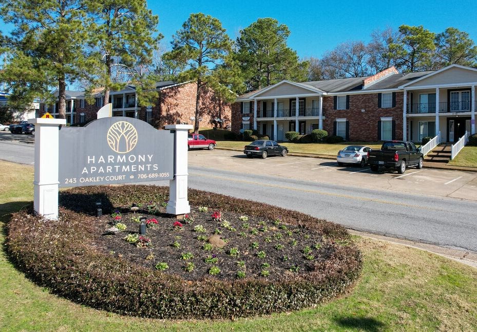 a sign apartments in front of a street