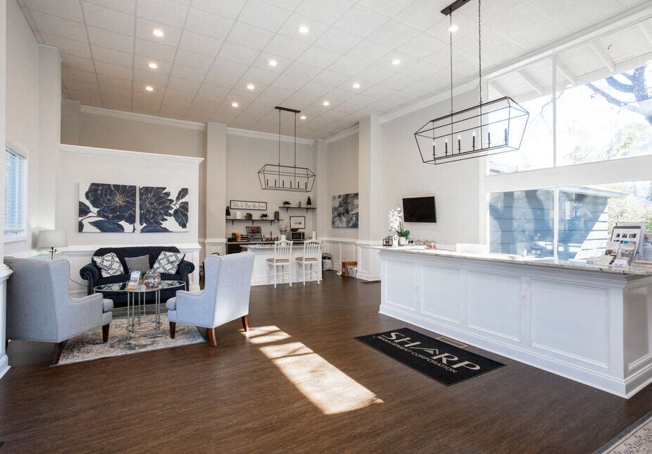 a large living room with a table and chairs