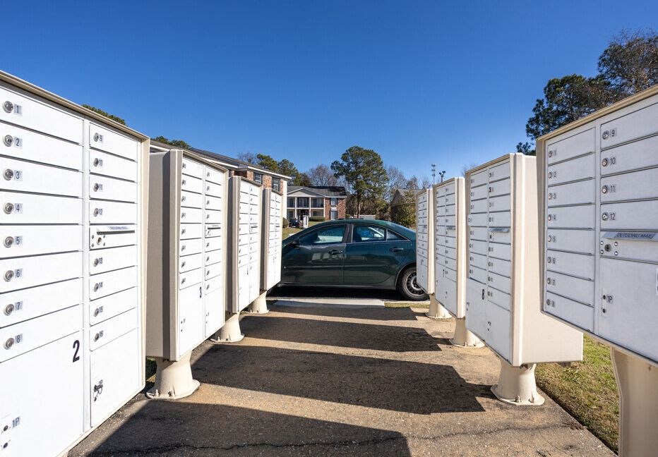 a car parked in a parking lot with white mailboxes