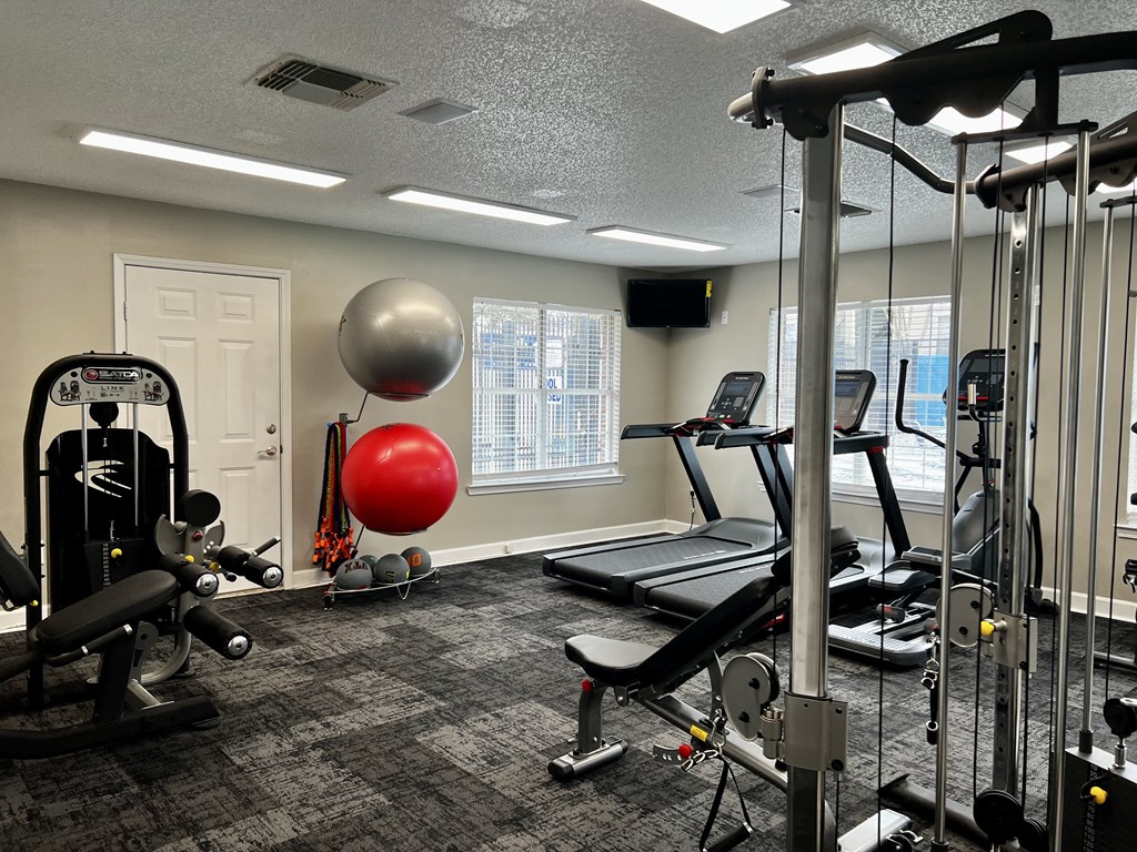 a fitness center with treadmills and other exercise equipment