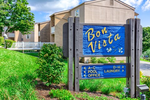 A sign for Bon Vista apartment complex with directions to the pool, office, and laundry.