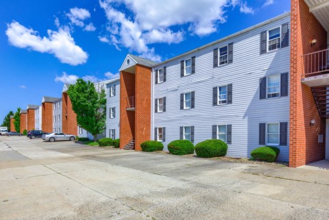 an empty parking lot in front of an apartment building