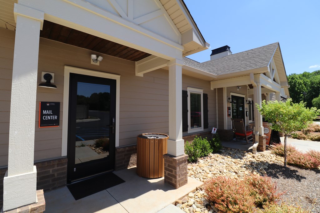 A mail center is located in a building with a porch.