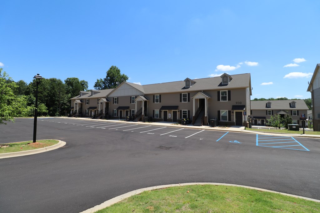 A parking lot with a blue painted arrow on the pavement.