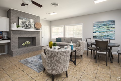 a living room with a fireplace and a table and chairs