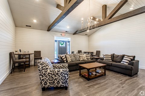 a living room with couches and chairs and a table