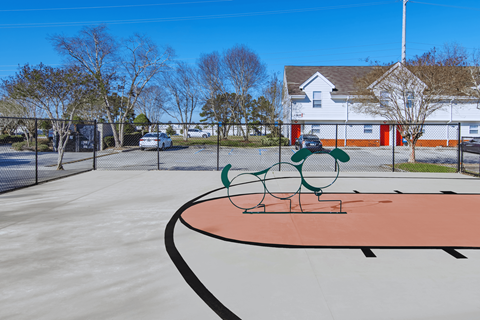 A playground with a slide and a basketball court.