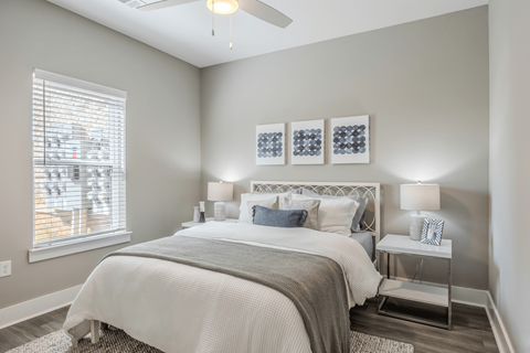 a bedroom with a bed and a ceiling fan