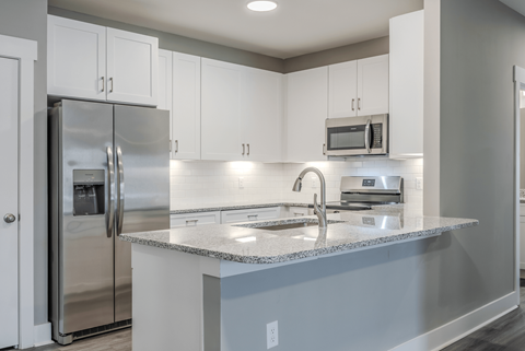 a kitchen with stainless steel appliances and a granite counter top