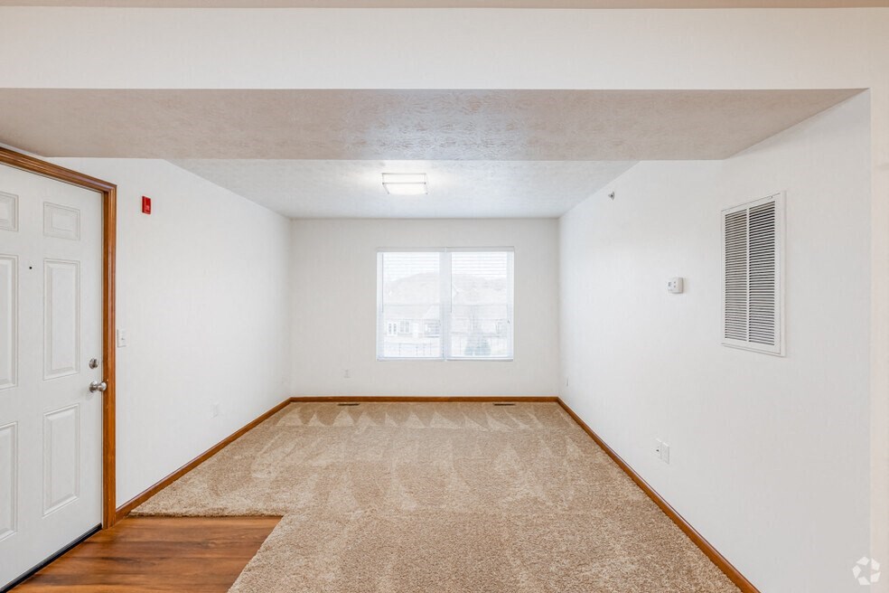 an empty room with a window and a door