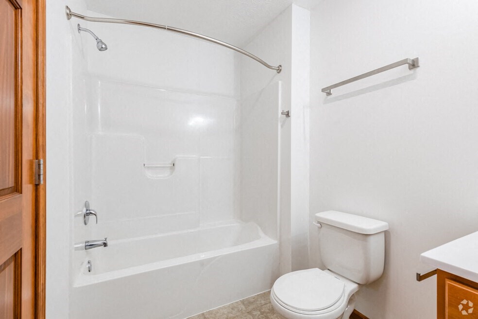 a white bathroom with a shower and a toilet