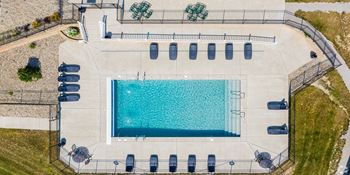 arial view of a swimming pool at a resort with umbrellas