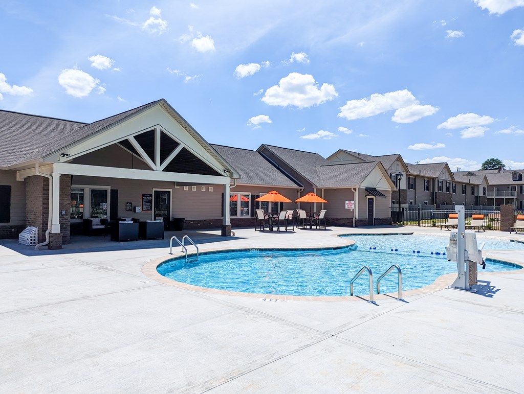 A pool area with a building in the background.
