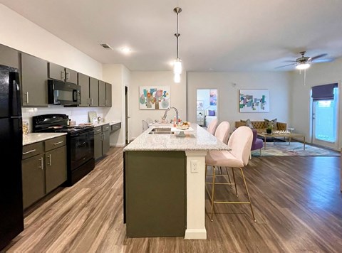 a kitchen and dining room with a marble counter top