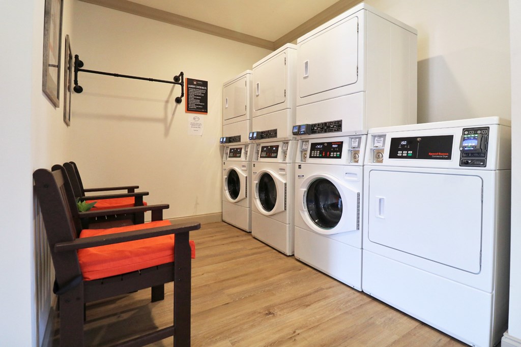 A laundry room with a washer and dryer stacked on top of each other.