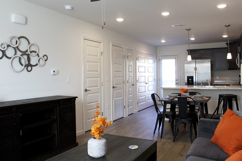 A modern living room with a fireplace and a dining area.