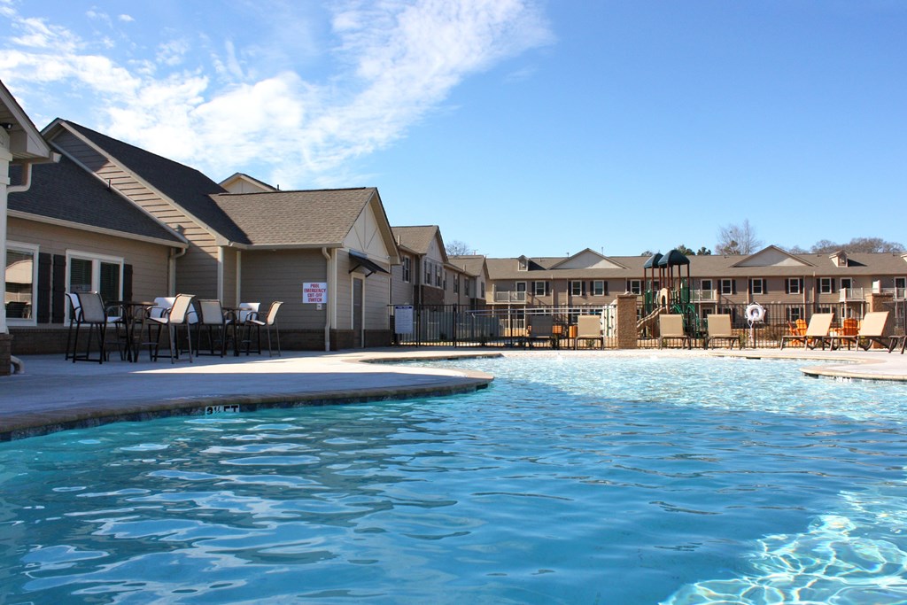 A swimming pool in front of a resort.