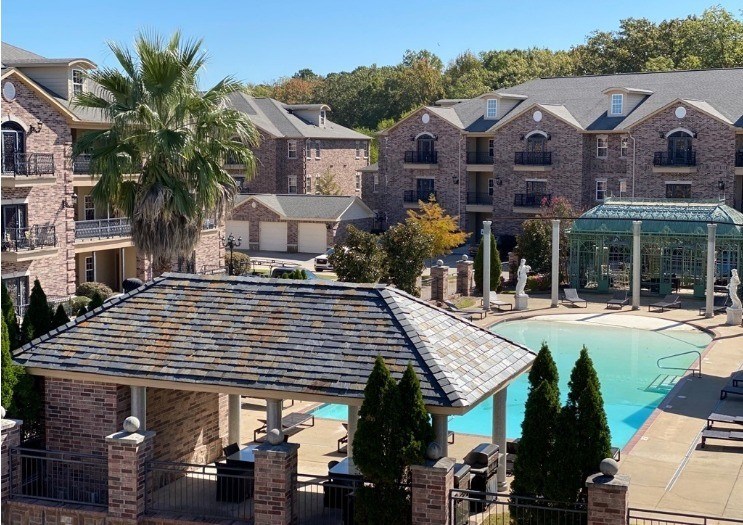 A large building with a pool in front.