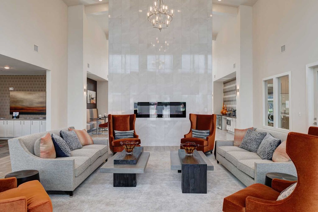 a living room with couches and chairs and a fireplace