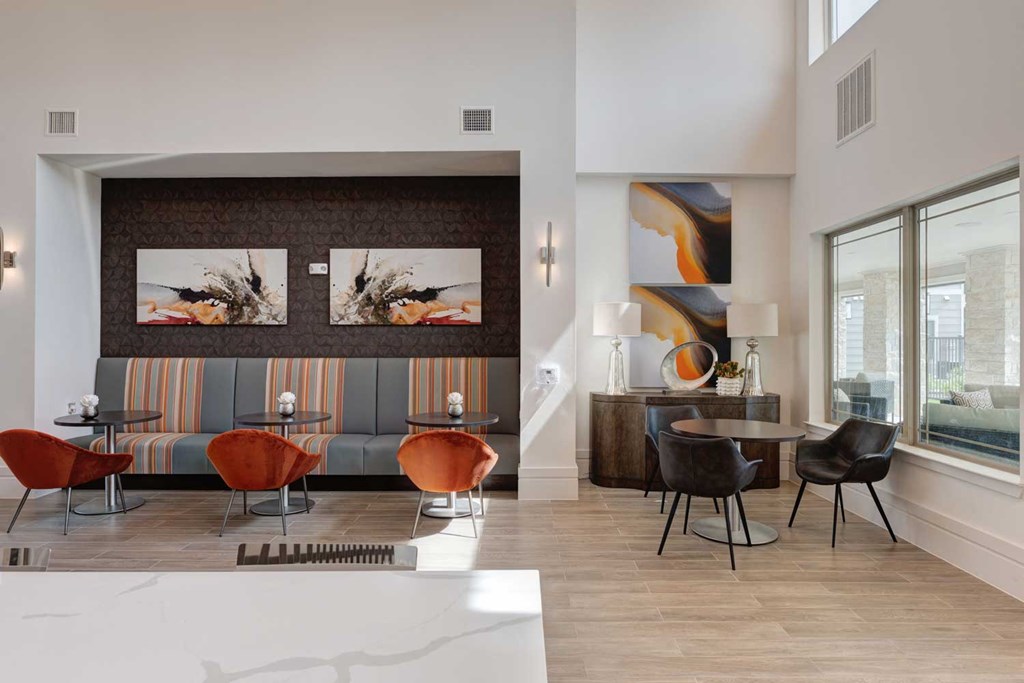 a living room with a table and chairs and a large window