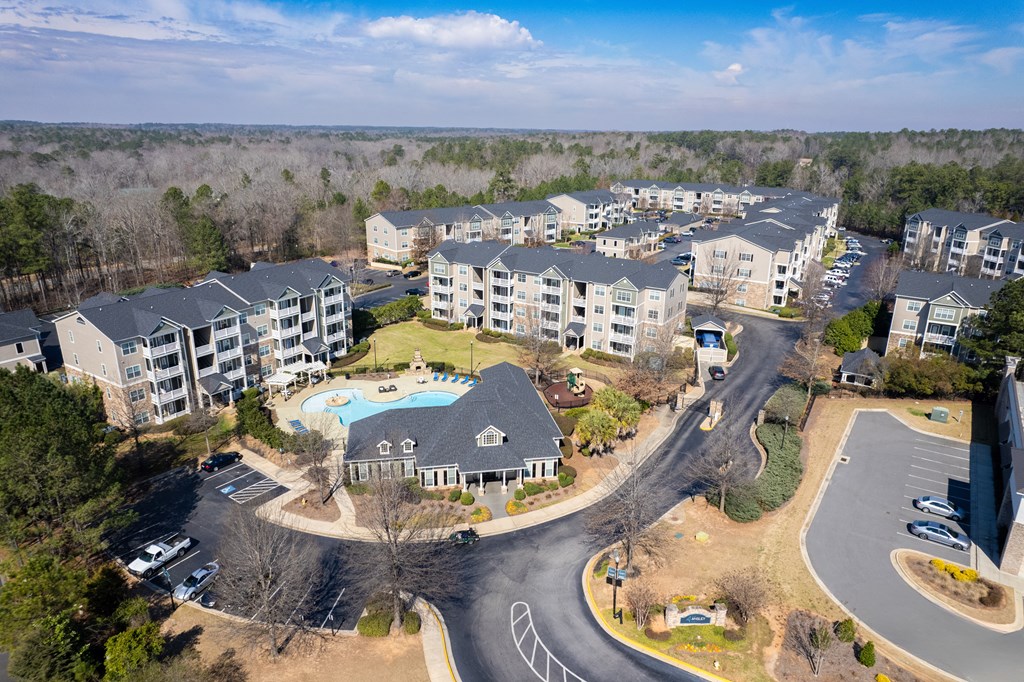 an aerial view of an apartment complex with a swimming pool