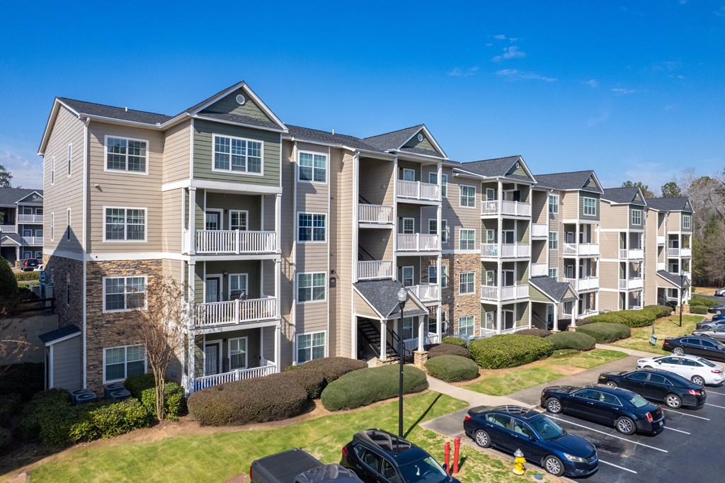 an apartment building with cars parked in front of it
