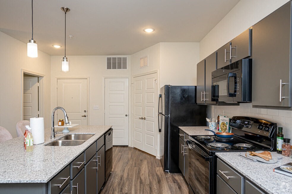 a kitchen with stainless steel appliances and granite counter tops