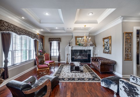 a living room with a fireplace and a couch and chairs