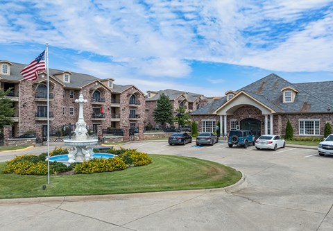 a large building with a fountain and an flag in front of it
