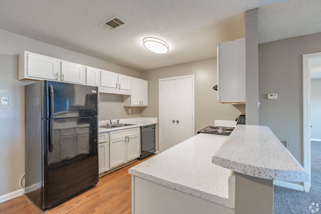 the preserve at ballantyne commons apartment kitchen with white cabinets and stainless steel appliances