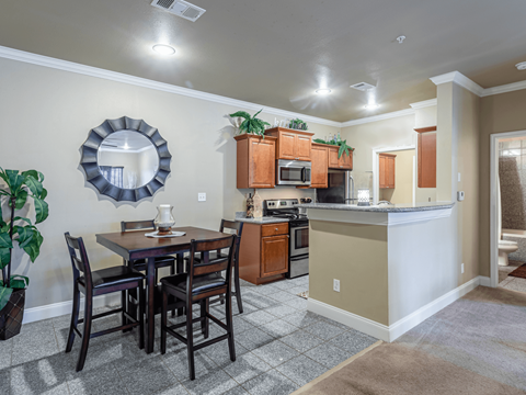 an open kitchen and dining area with a table and chairs