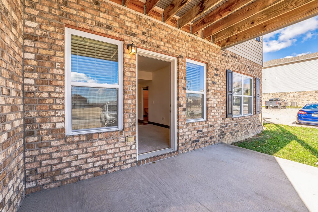 the entrance to a brick building with an open door